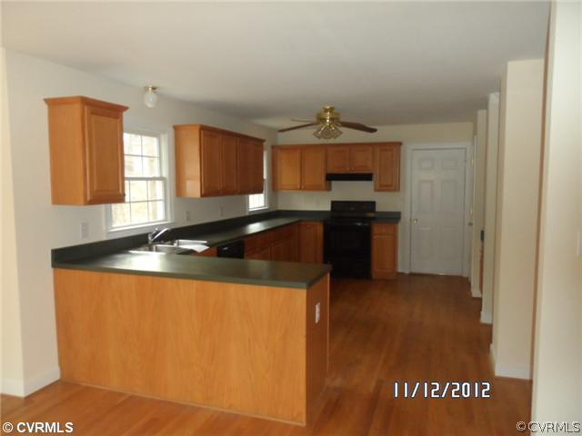 3769 Three Chopt Road Gum Spring, VA 23065 - Photo 4 of 10 a kitchen with granite countertop a sink and a stove top oven