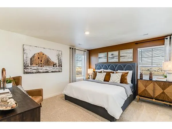 a bedroom with a bed and glass window