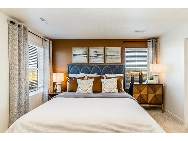 a bedroom with a large bed and a large window