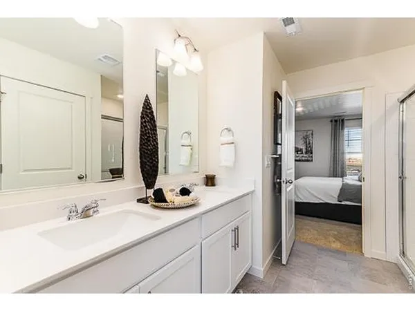 a en suite bathroom with double sink and a mirror