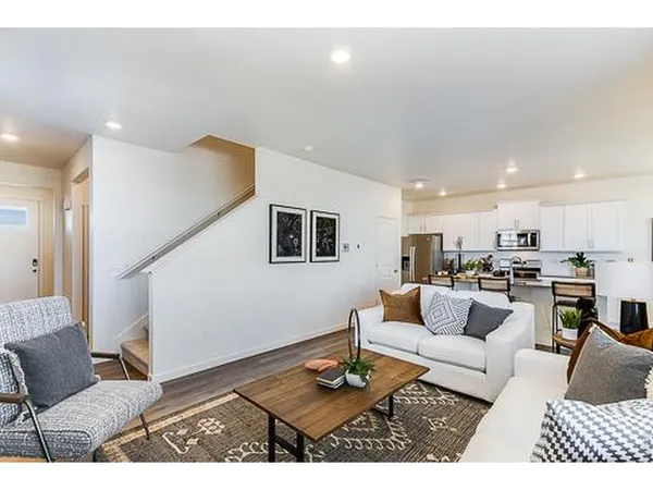 a living room with furniture and view of kitchen
