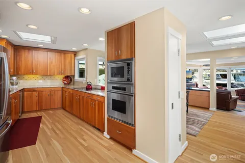 a kitchen with stainless steel appliances granite countertop a refrigerator and a sink