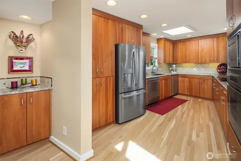 a open kitchen with stainless steel appliances granite countertop a stove and cabinets