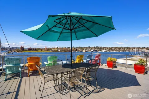 a view of a balcony with furniture and umbrella