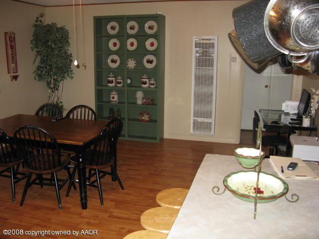 4217 Parker Street Amarillo, TX 79110 - Photo 5 of 13 a dining room with furniture and wooden floor