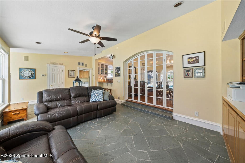 1110 Riverside Drive Titusville, FL 32780 - Photo 13 of 50 a living room with furniture a ceiling fan and a window
