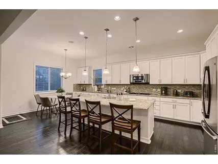 a kitchen with center island table and chairs