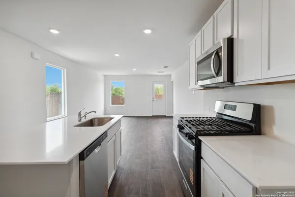 a kitchen that has a sink and a stove