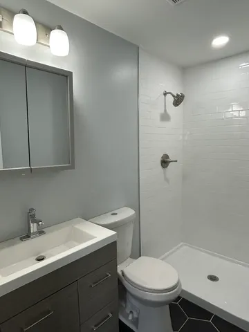 a bathroom with a sink toilet and shower