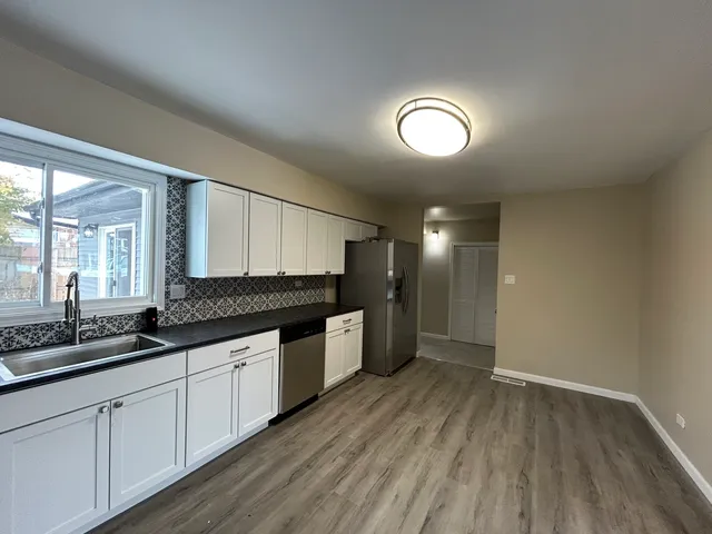 a large kitchen with a lot of counter space and a wooden floors