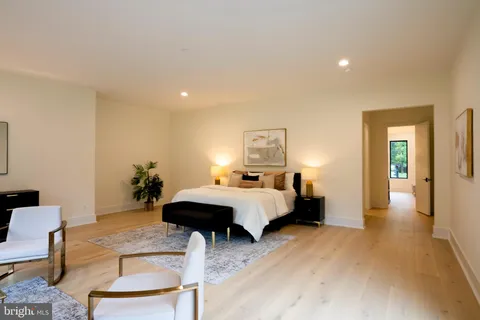 a spacious bathroom with a double vanity sink a mirror and a bathtub