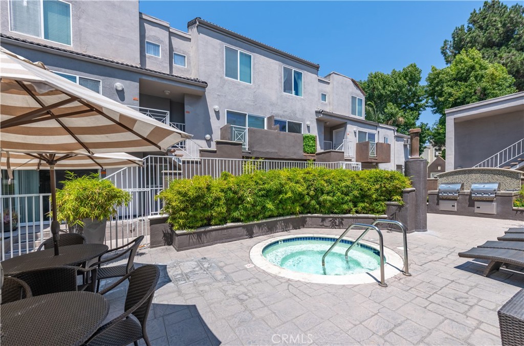 355 North Maple Street, Unit 203 Burbank, CA 91505 - Photo 11 of 15 a white building with a bench and a potted plant