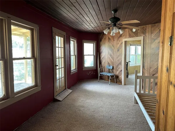 a view of a livingroom with a large window and stairs