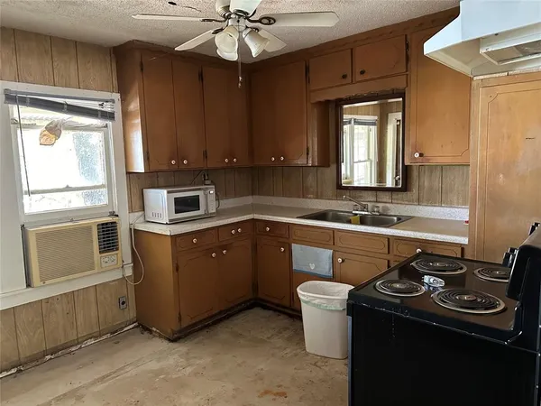 a kitchen with a sink appliances and cabinets