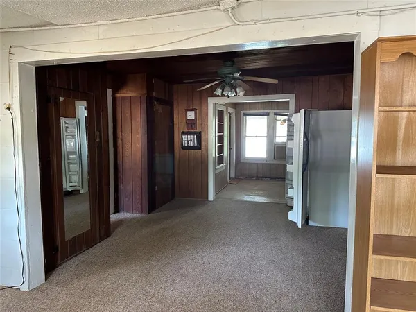 a view of a hallway with wooden shelves