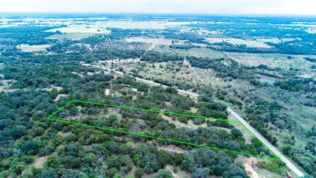 an aerial view of a houses with a yard