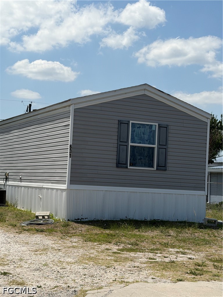 631 Stanton Street Clewiston, FL 33440 - Photo 1 of 24 a view of a house with a backyard