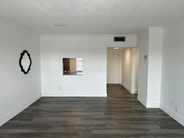 a view of room with wooden floor and stairs