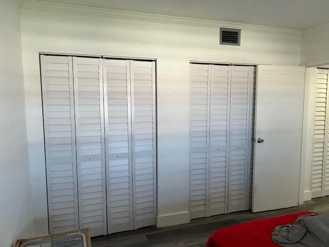 a view of walk in closet with empty racks