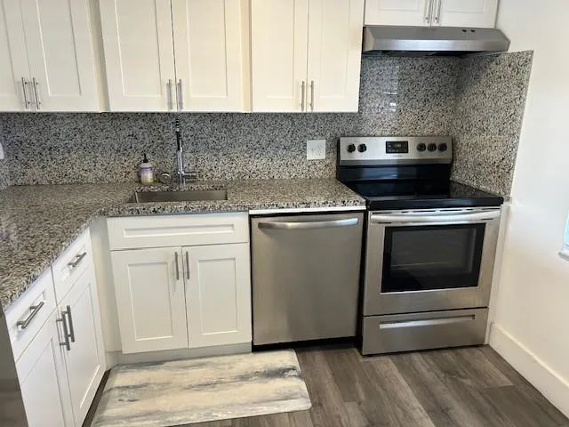 a kitchen with a stove and cabinets