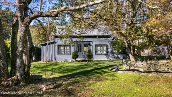 a view of a house with backyard porch and sitting area