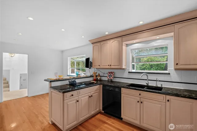 a kitchen with a sink stove and cabinets