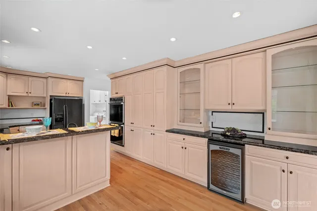 a kitchen with stainless steel appliances a stove refrigerator sink and cabinets