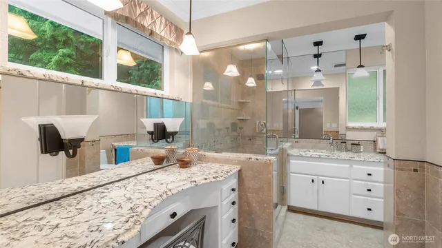 a bathroom with a double vanity sink and a mirror