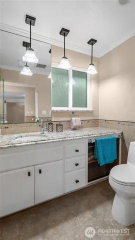 a bathroom with a granite countertop sink mirror and toilet