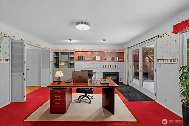 a living room with furniture a rug and a fireplace