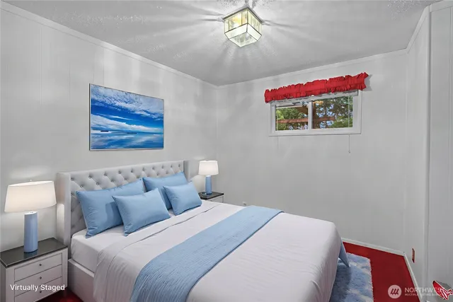 a bedroom with a bed and a painting on the wall