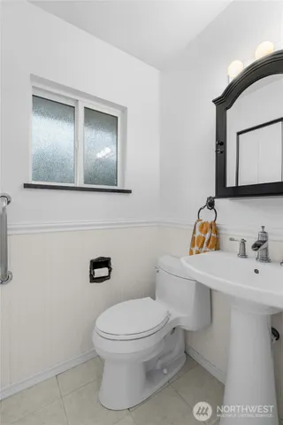 a white toilet sitting next to a bathroom sink