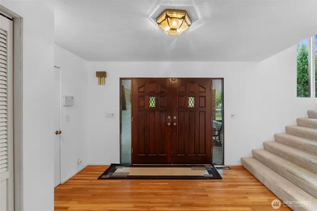 a view of room with stairs and wooden floor