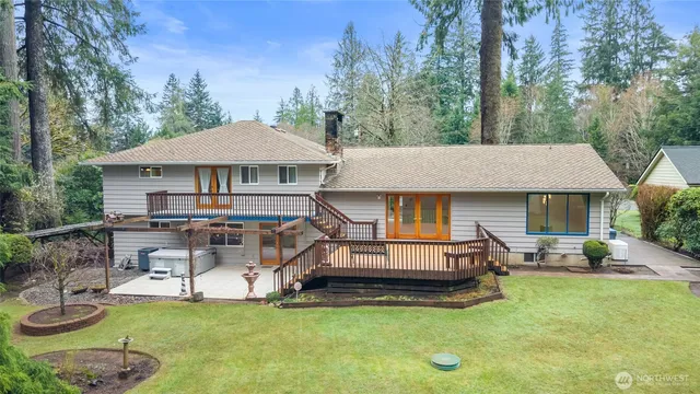 a view of a patio with chair and table under an umbrella