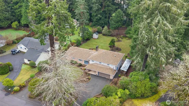 an aerial view of a house with a yard