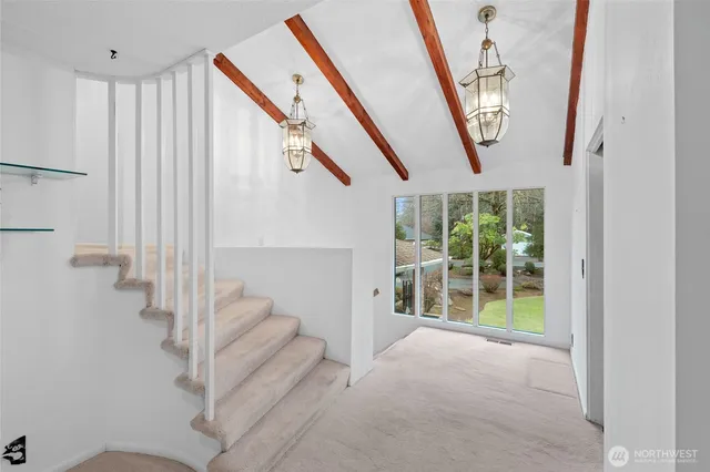 a view of entryway and hall with a front door