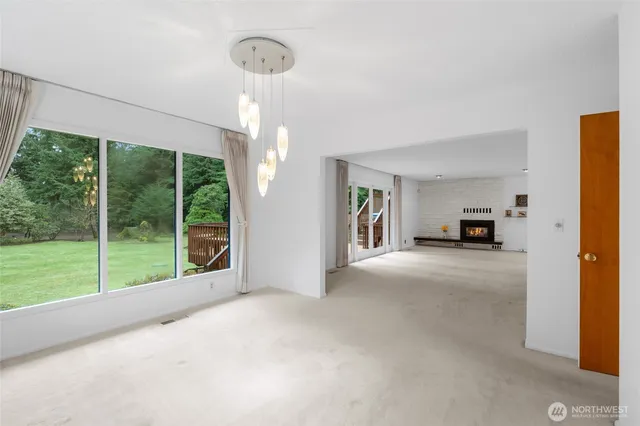 a living room with furniture and a floor to ceiling window