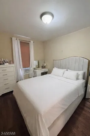 a large bed sitting in a bedroom next to a window
