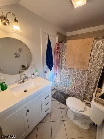 a bathroom with a sink mirror vanity and toilet