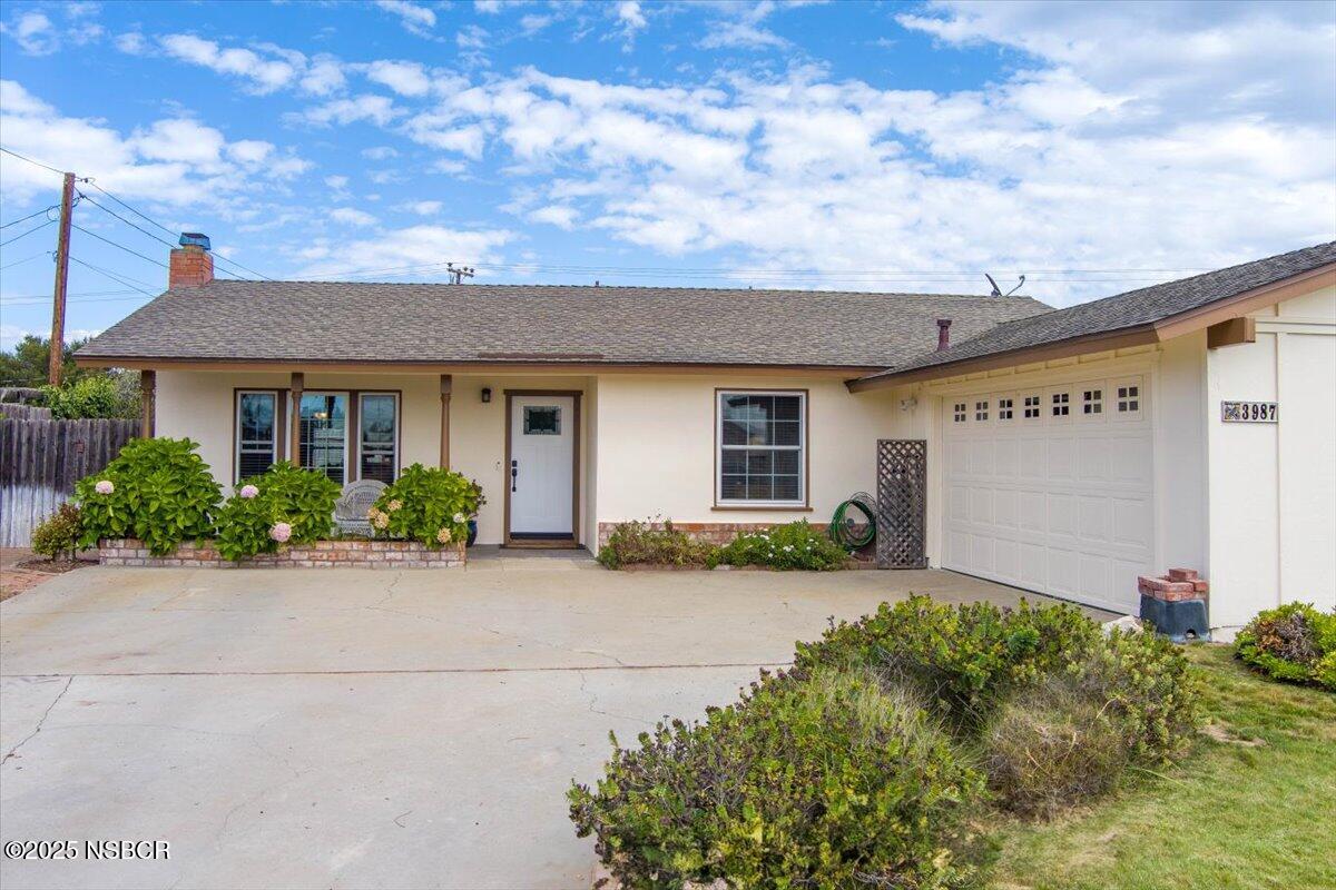 3987 Agena Way Lompoc, CA 93436 - Photo 11 of 40 a front view of house with yard and trees in the background