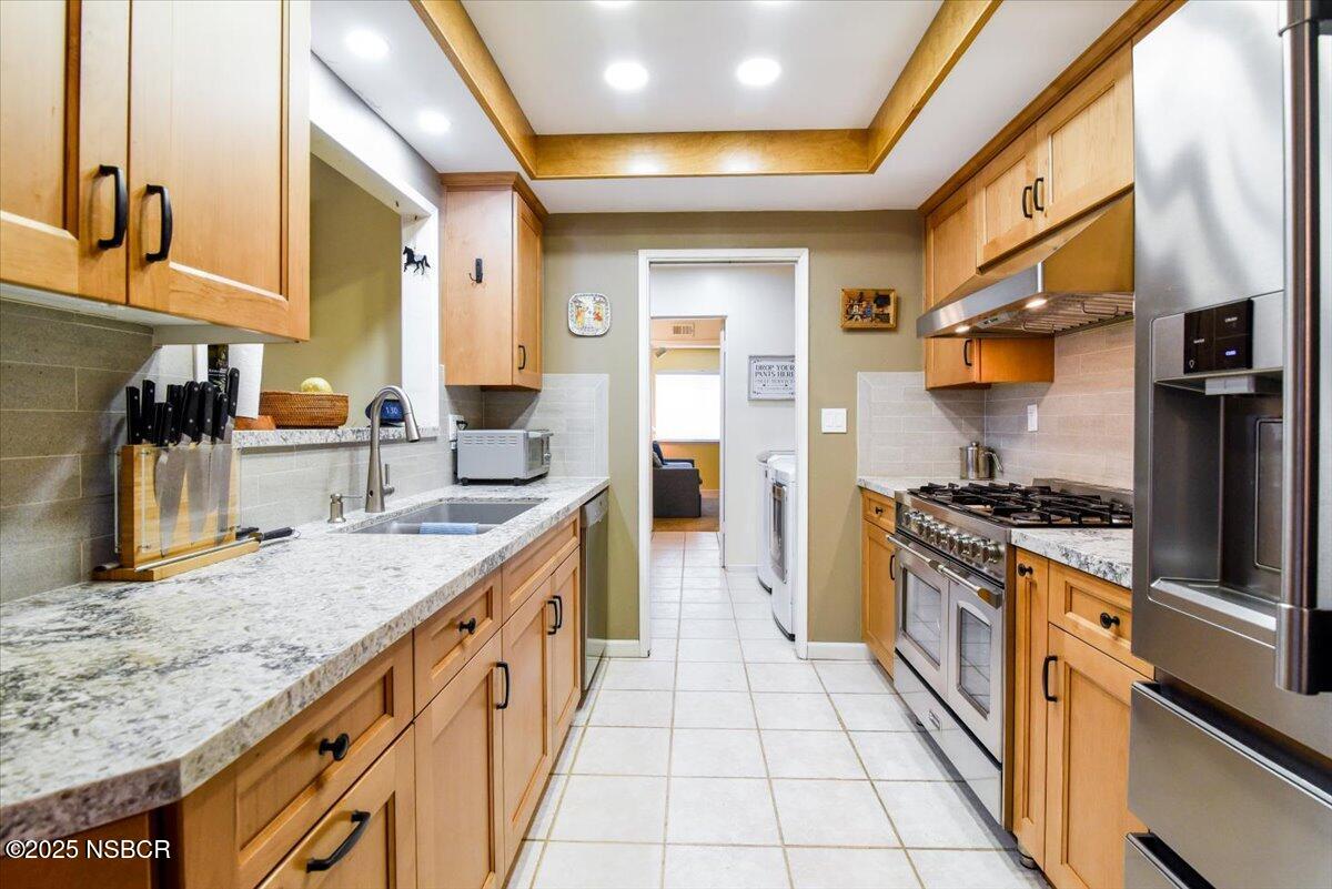 3987 Agena Way Lompoc, CA 93436 - Photo 19 of 40 a kitchen with stainless steel appliances granite countertop a sink and a stove