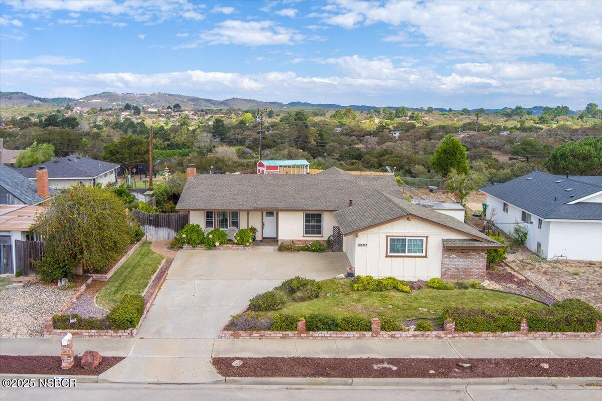 3987 Agena Way Lompoc, CA 93436 - Photo 2 of 40 a front view of a house with a yard and mountain
