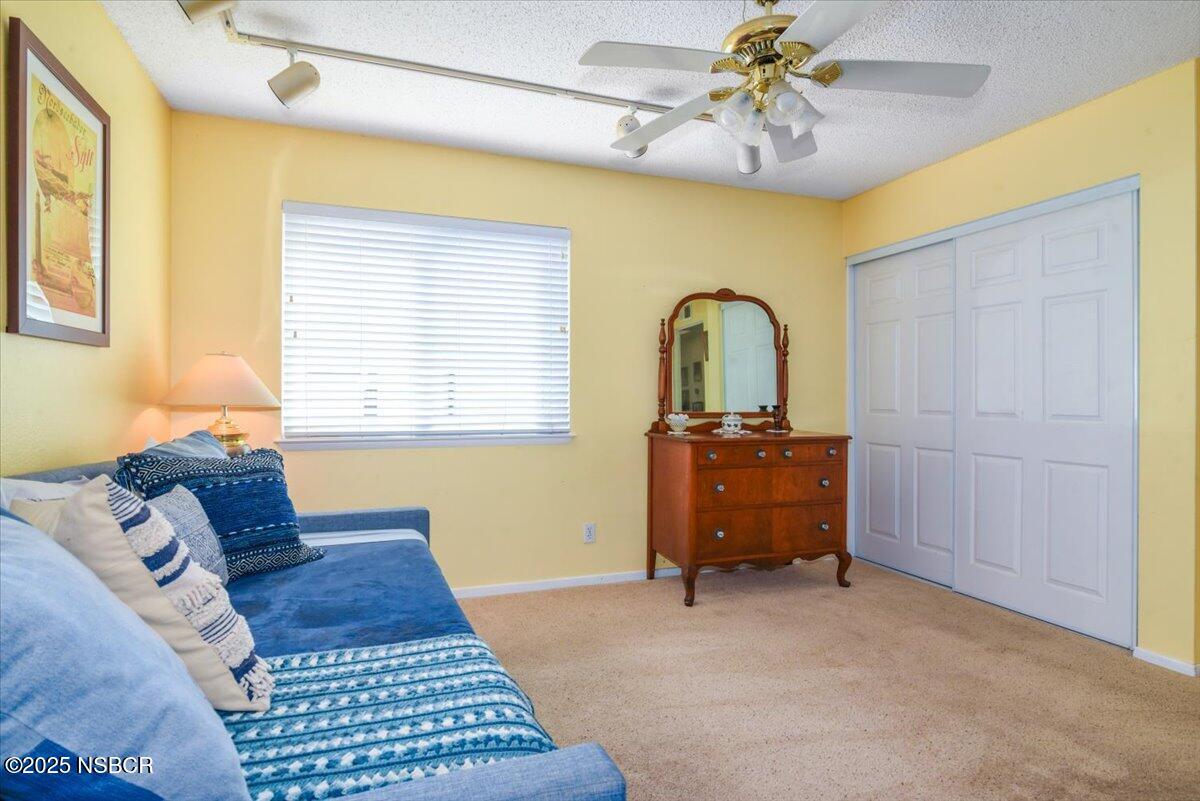 3987 Agena Way Lompoc, CA 93436 - Photo 23 of 40 a bedroom with a bed and a chandelier