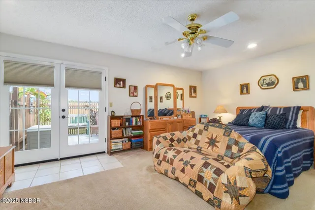 a bedroom with a balcony a bed and a chandelier