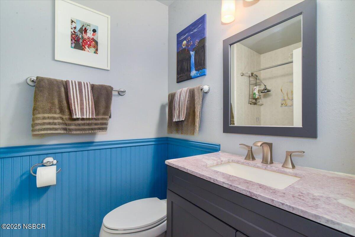 3987 Agena Way Lompoc, CA 93436 - Photo 31 of 40 a bathroom with a granite countertop toilet sink and mirror