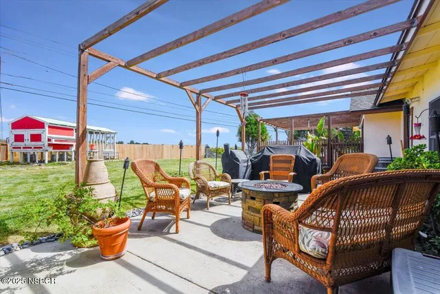 a view of a house with backyard and sitting area