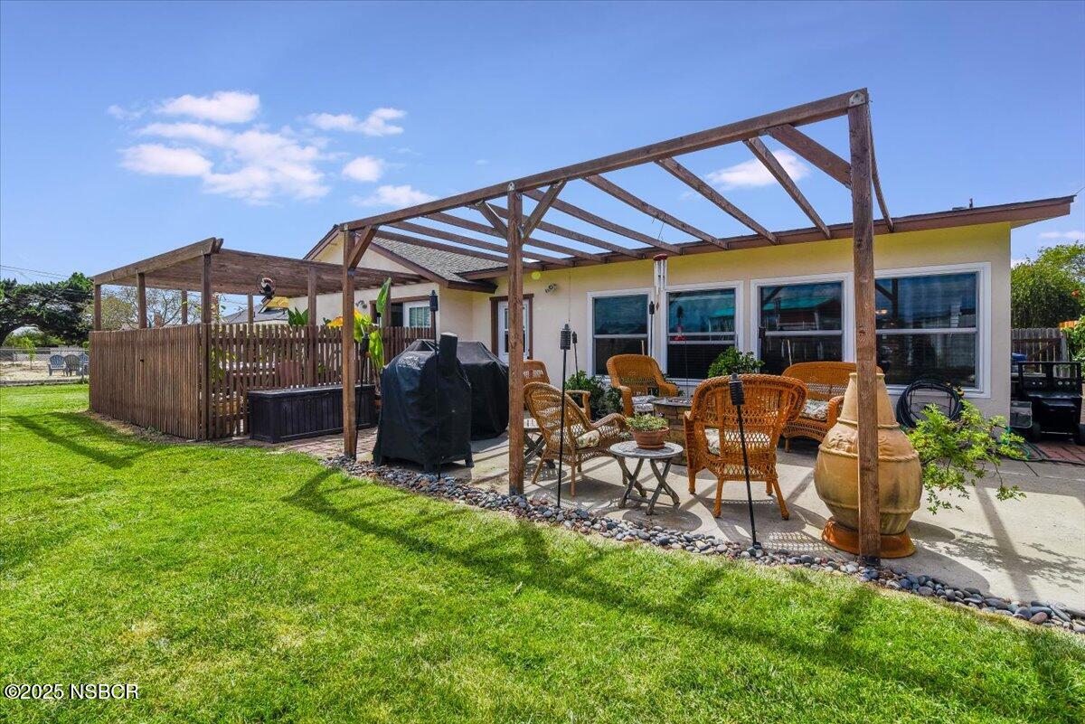 3987 Agena Way Lompoc, CA 93436 - Photo 34 of 40 a view of a patio with table and chairs under an umbrella