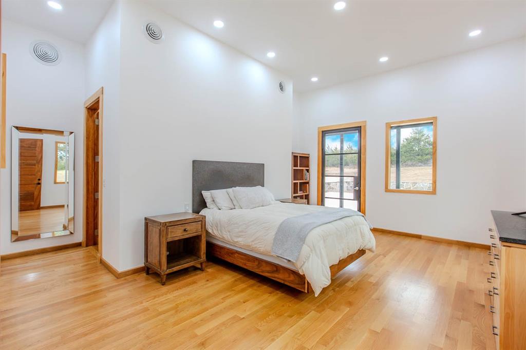 511 County Road 4264 Bonham, TX 75418 - Photo 23 of 40 a large bedroom with a bed and wooden floor