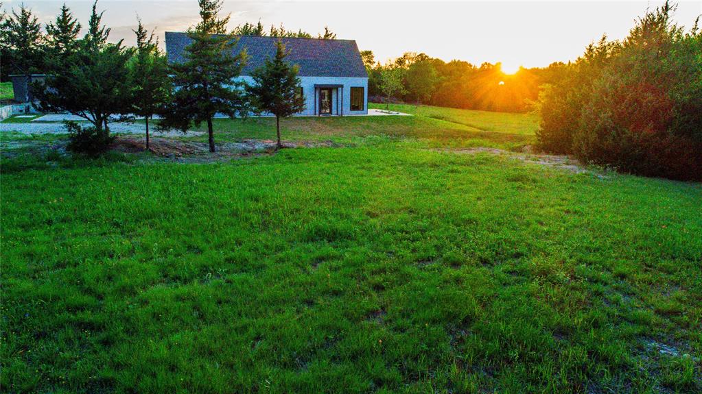 511 County Road 4264 Bonham, TX 75418 - Photo 4 of 40 a view of house with backyard