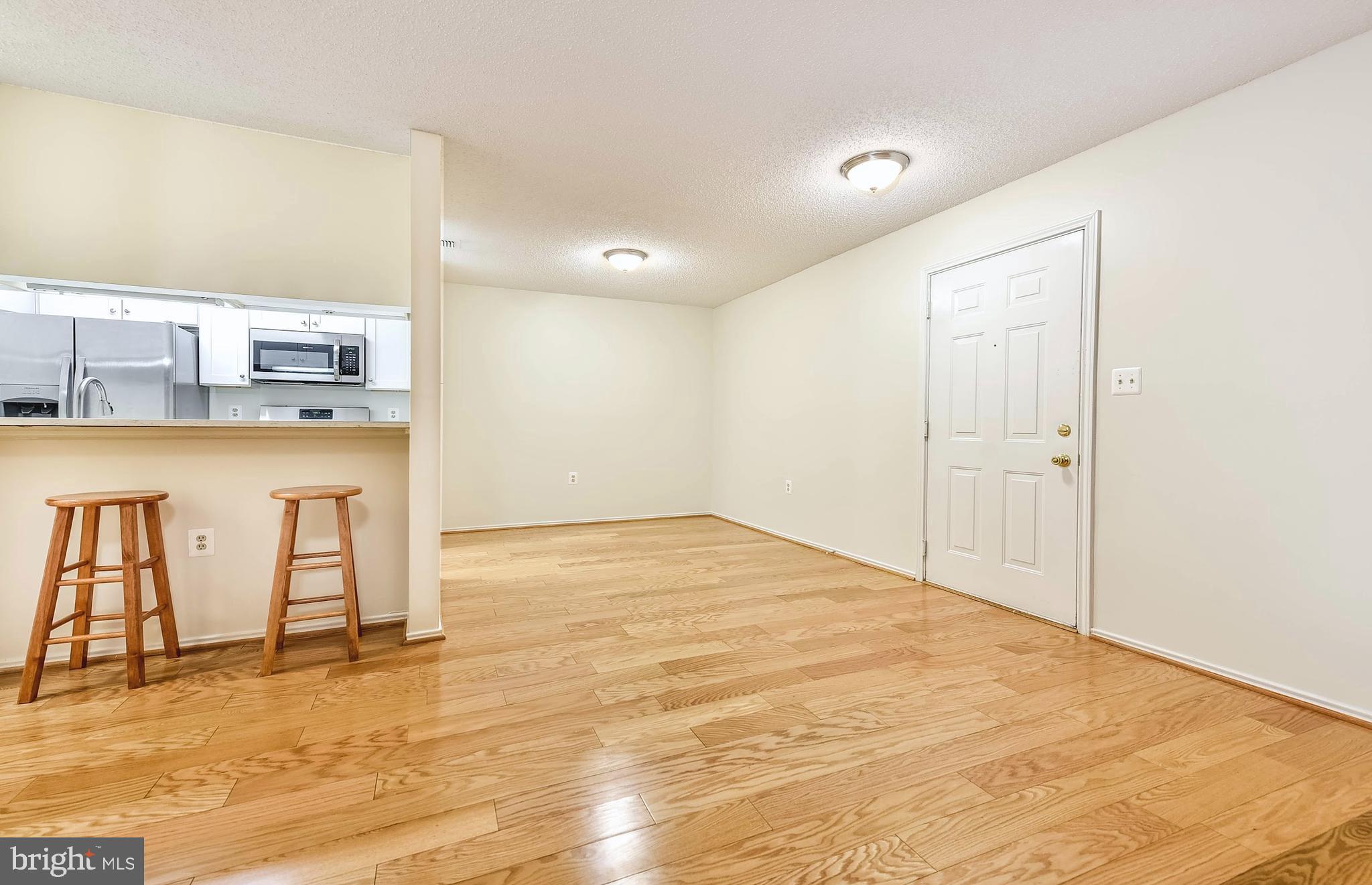 21009 Timber Ridge Terrace, Unit 104 Ashburn, VA 20147 - Photo 3 of 18 View of the Bar and Dining Area